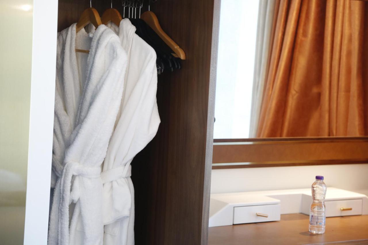 Waterfront Hotel Apartment Lusail Exterior photo A bathrobe hanging in a closet